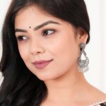 Women’s silver Indo-Western drop earrings with matching necklace, fashion artificial jewellery, perfect for festive, wedding, and party occasions in India.